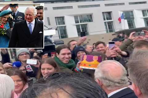 Moment German fan tries to put Burger King crown on Charles’ head – as giggling King gives..