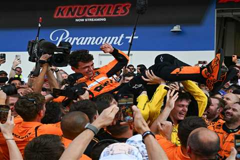 Lando Norris celebrates first Formula 1 win with insane dive into crew, champagne spike