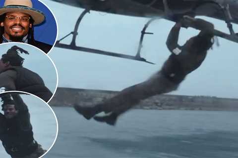 Cam Newton jumps onto moving helicopter from speeding boat in wild reality show stunt