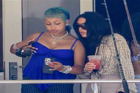 Kim Kardashian Makes Waves in Acne Snake  Print Top and Skims Crocodile Bikini Top and Capris..