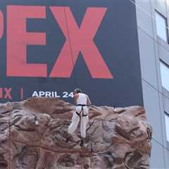 Charlize Theron Climbs the Walls of Times Square to Promote New Movie 'Apex'
